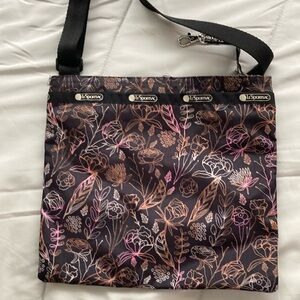 Pretty slim bag w/ deep pockets. 
10.5 w x 9.5 l / adjustable strap 36” (total)